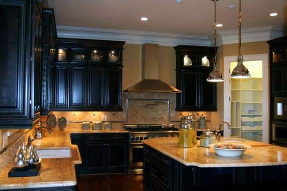 Brown walls with black kitchen cabinets and pendent light over island kitchen design 