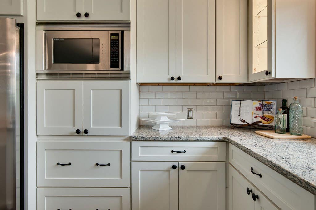 Kitchen design features white cabinets and Built-in Microwave Upper Cabinet 