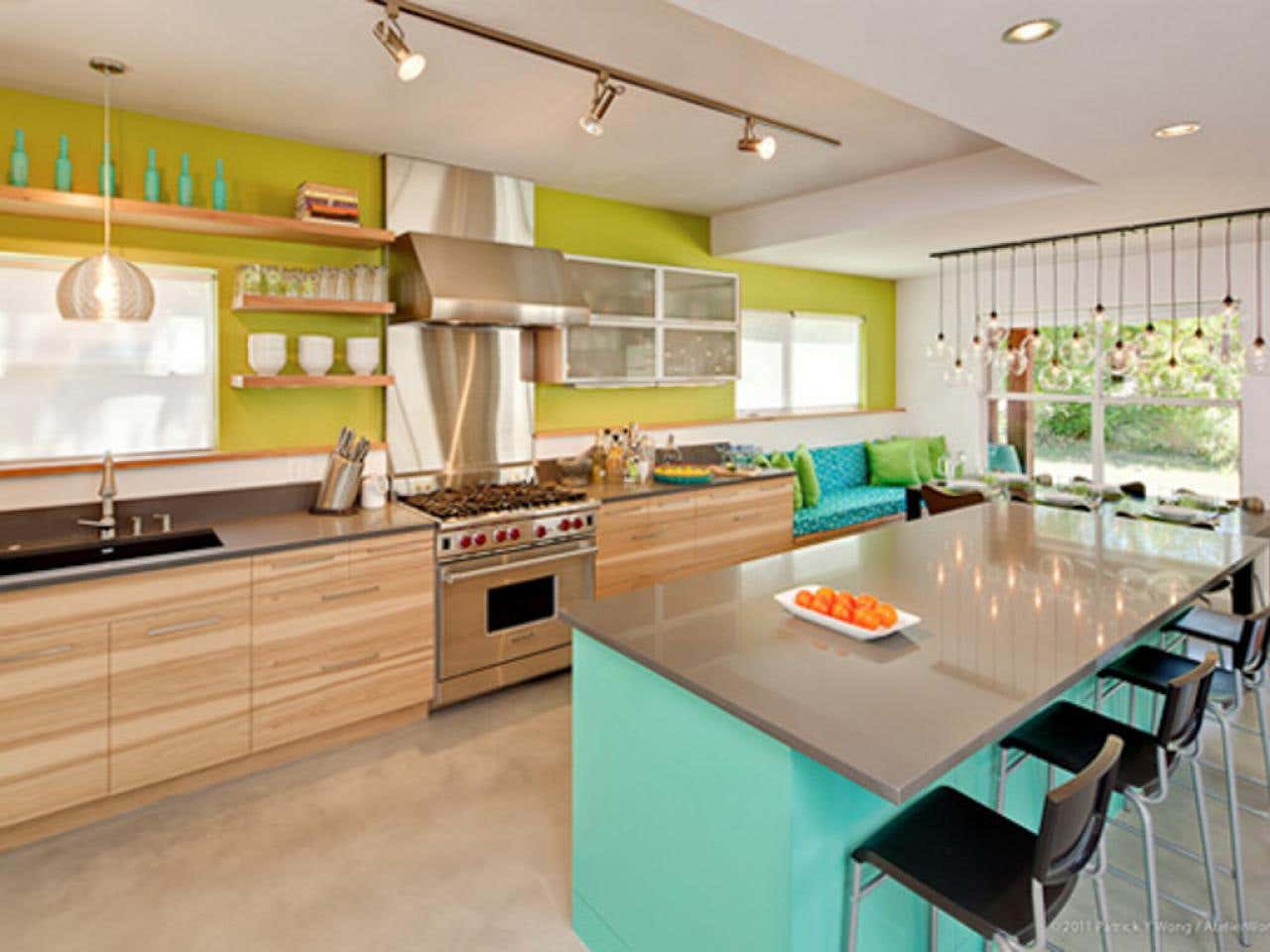 Natural Wood cabinets paired with electric green walls and stainless steel countertops and appliances 