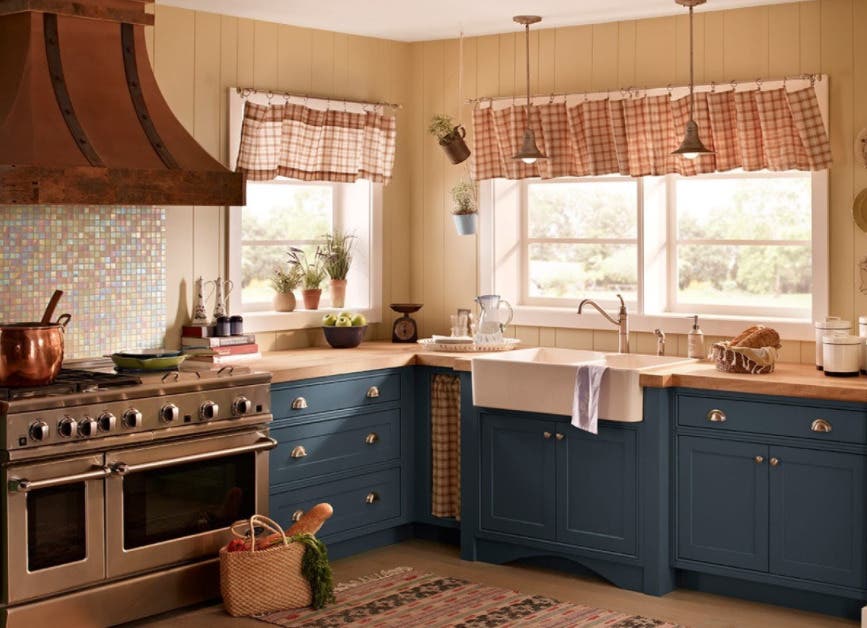 Beautiful Latte wall color paired with blue kitchen cabinets and silver hardware