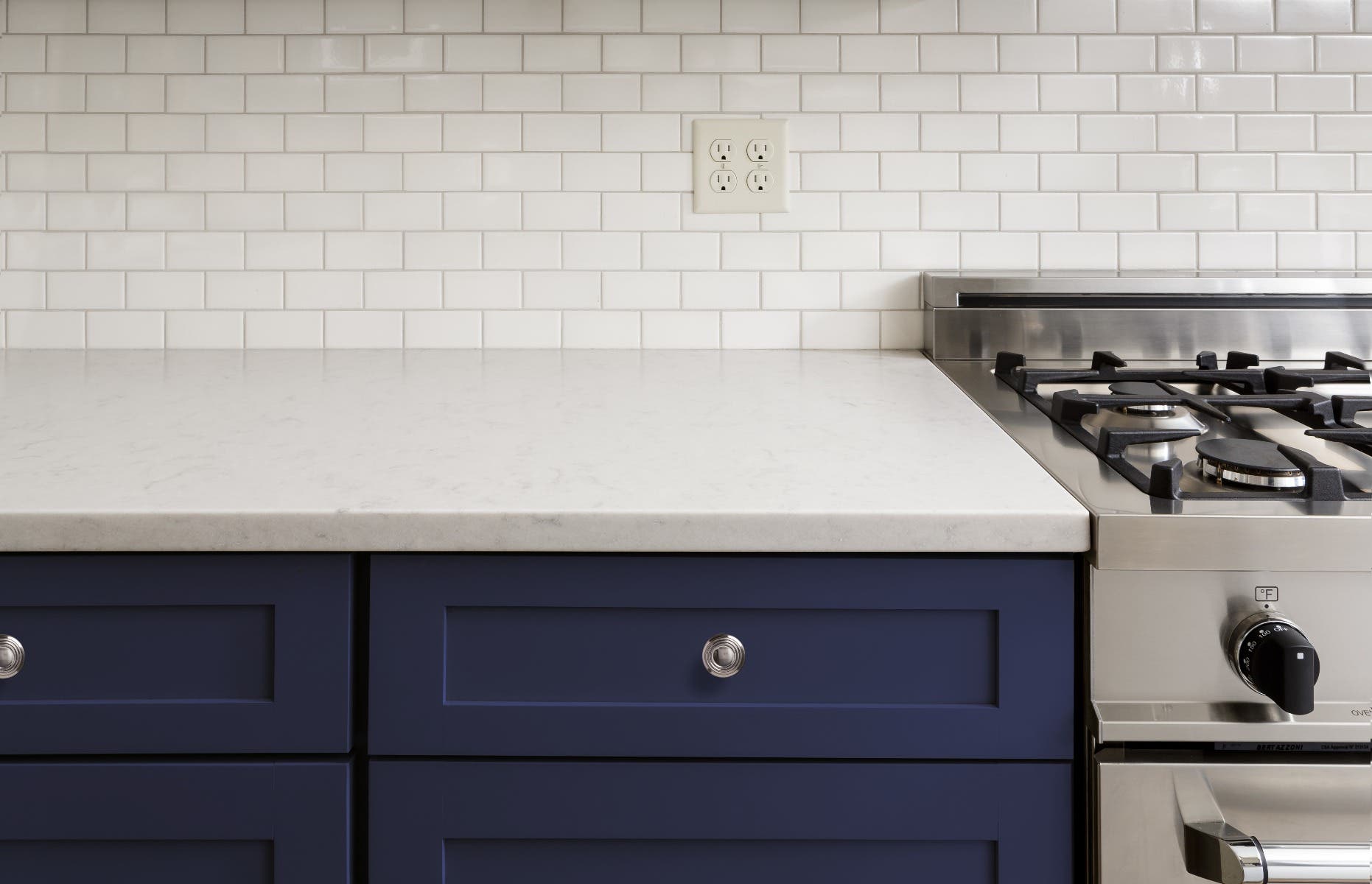 navy blue shaker cabinets white backsplash