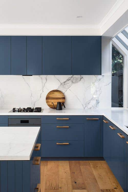 Gold hardware with blue kitchen cabinets