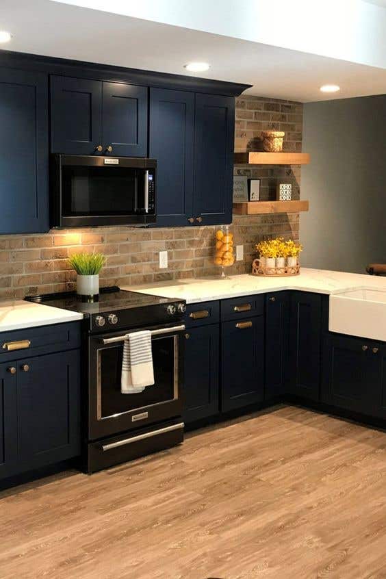 Brick backsplash with blue kitchen cabinets