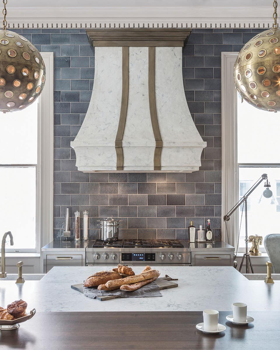 Elegant Chimney hood with dark tile backlash 