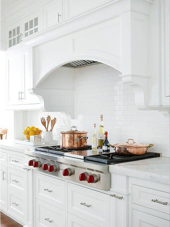 concealed hood with white shaker cabinets 