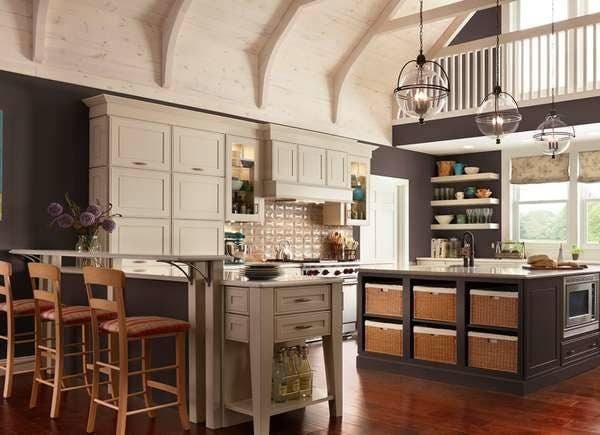 Chocolate wall color paired with light colored cabinetry