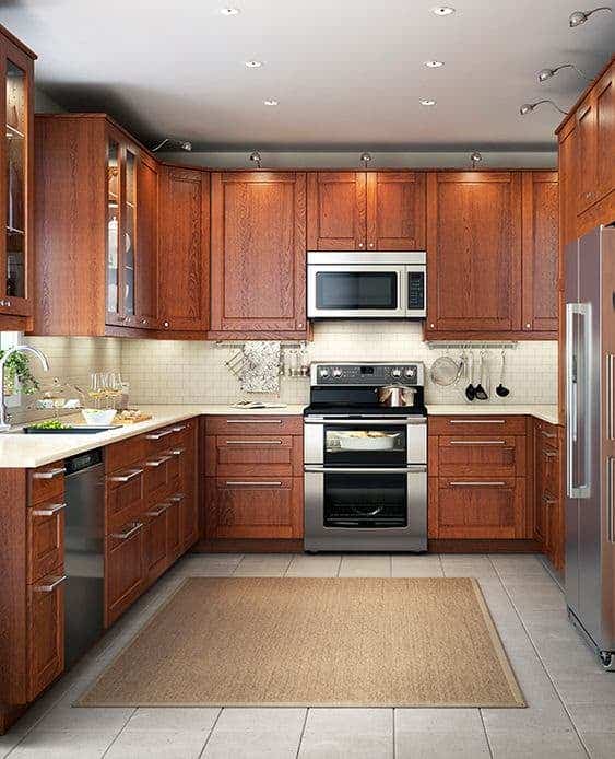 Cherry Cabinets with a Light Backsplash and steel appliances 