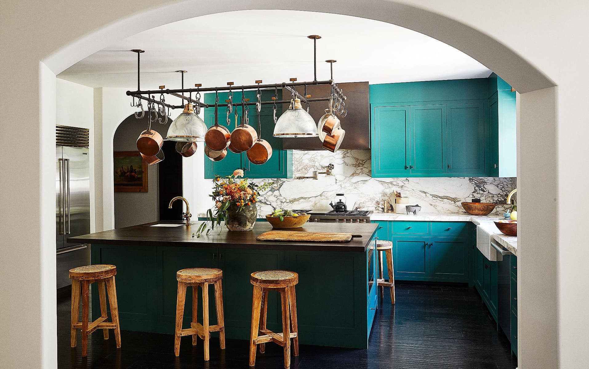 Mix bright colored cabinets paired with dark materials like island countertop, wood stools and copper accents.