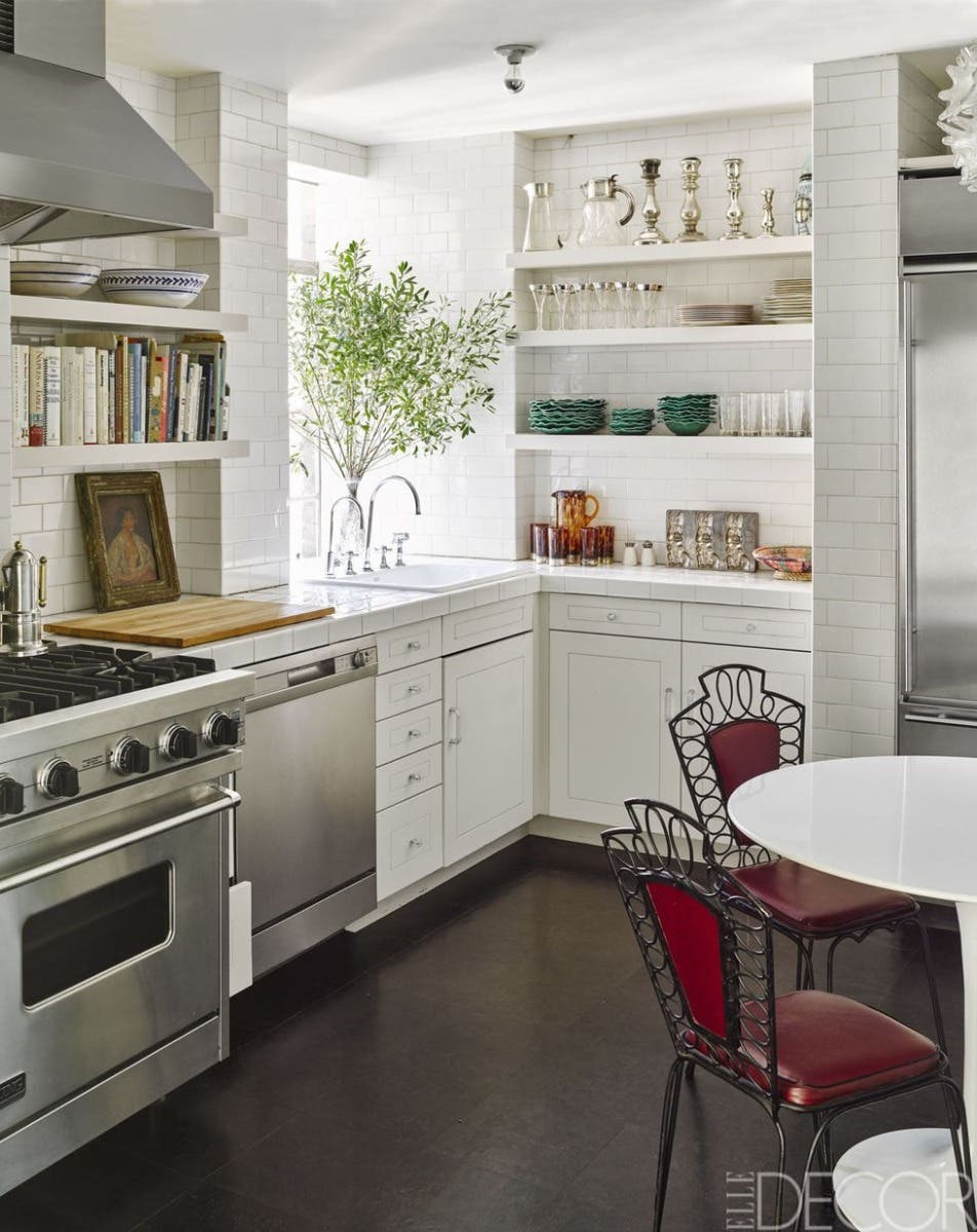 White kitchen design with shaker cabinets and subway wall tiles.