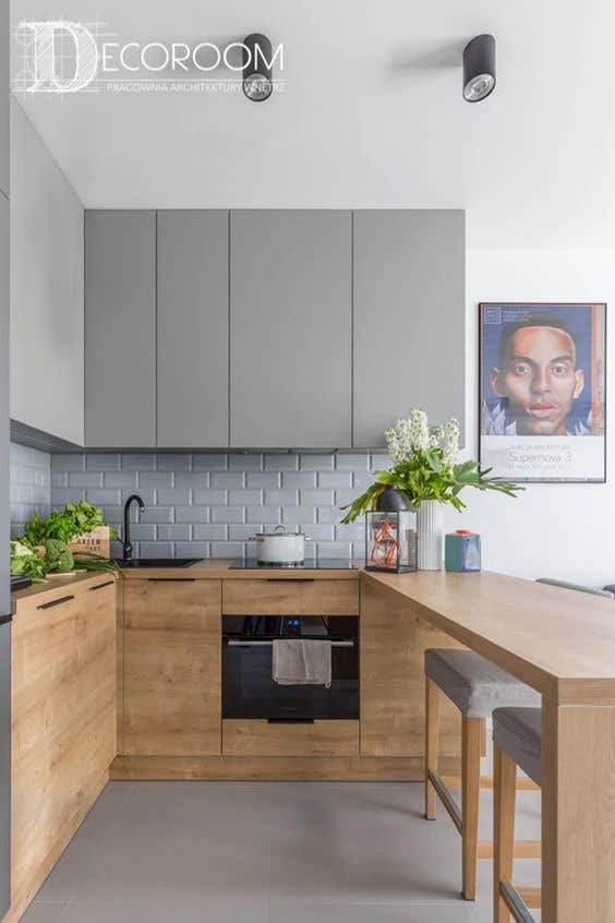 Two tone themed kitchen paired with flat panel gray and natural tone cabinets and tile flooring