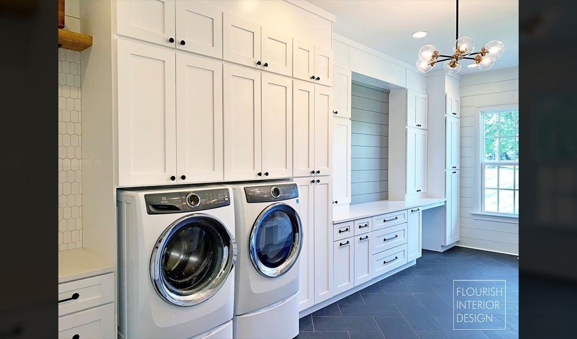 laundry room with white cabinets and washer 