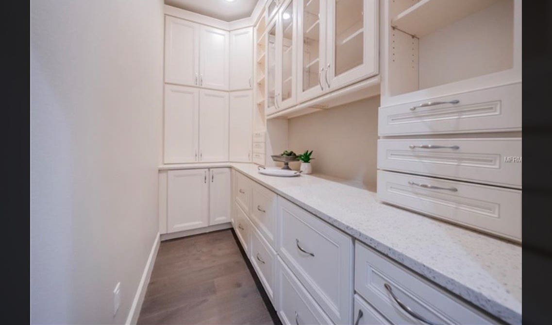 Mudroom with white cabinets