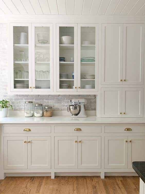 open frame kitchen cabinet doors paired with gold hardware