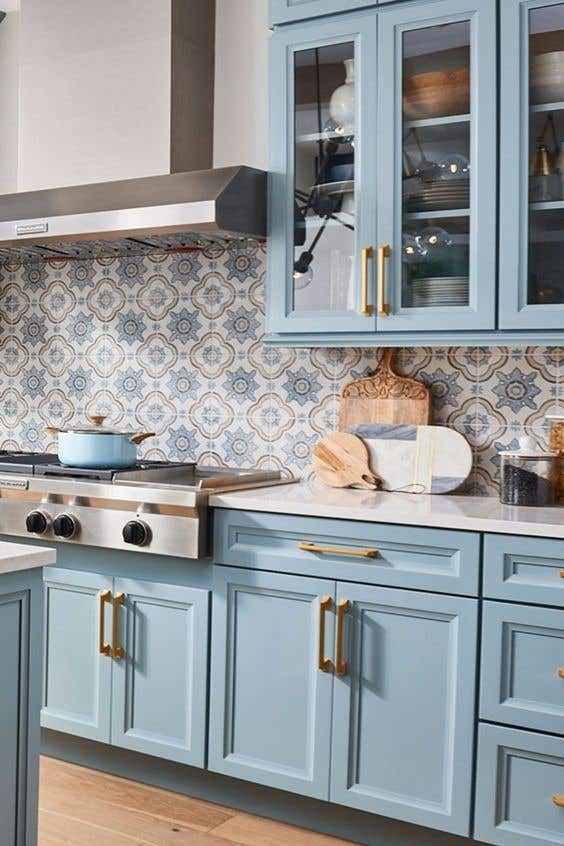 Pattern backsplash with blue kitchen cabinets