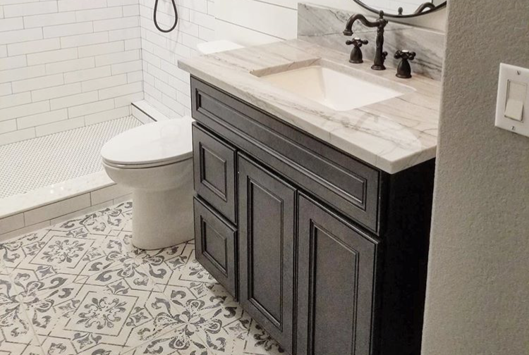 Rustic Butterfly vanity with sink, marble countertop, metal fixture, White WaterSense Elongated Toilet and shower space