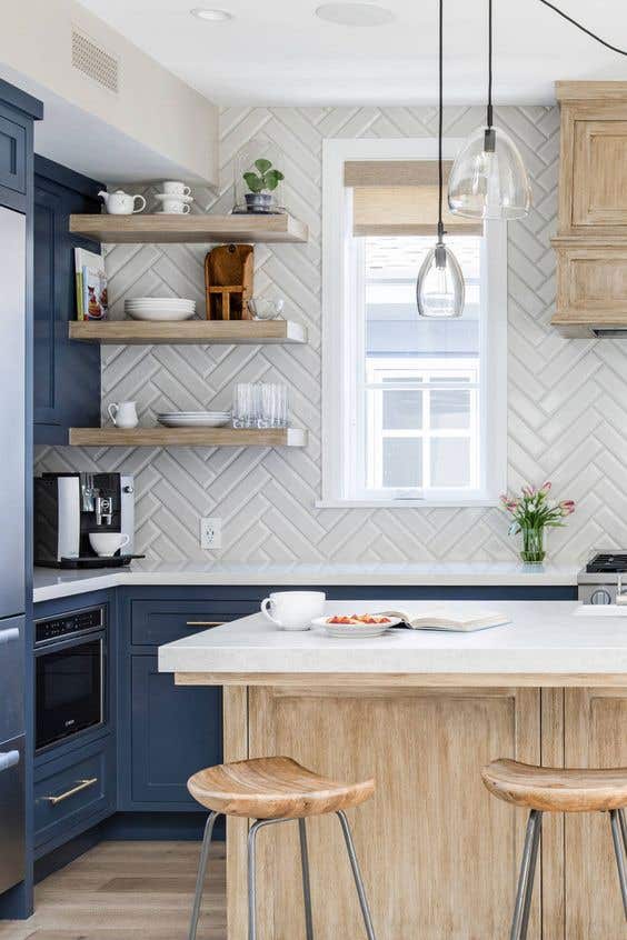 Subway tile backsplash with blue kitchen cabinets