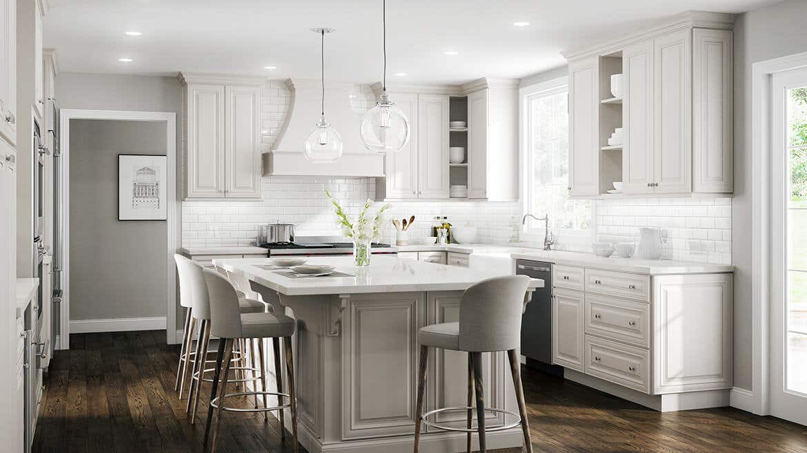 Traditional kitchen theme with linen cabinets, silver hardware and wooden flooring