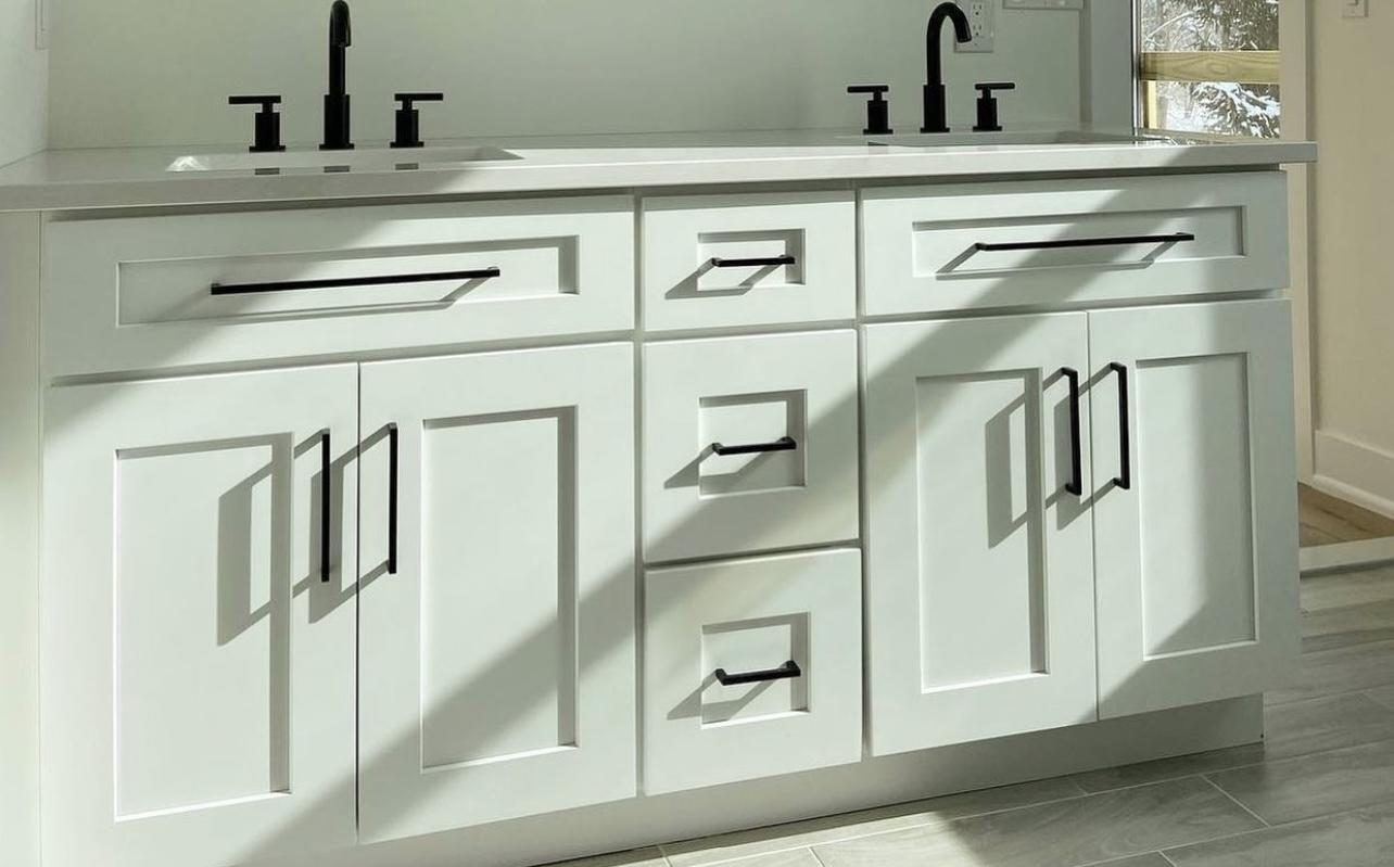 White shaker bathroom vanities with black fixtures