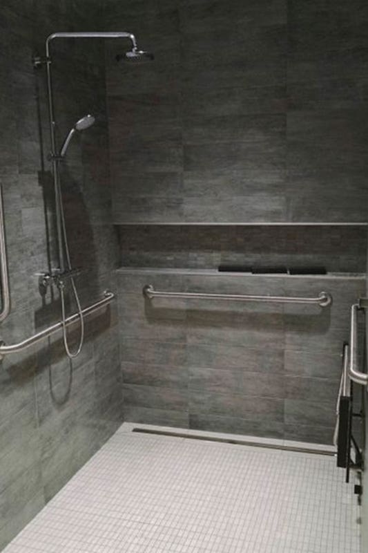 Shower area with stainless steel fixture and accessible features 