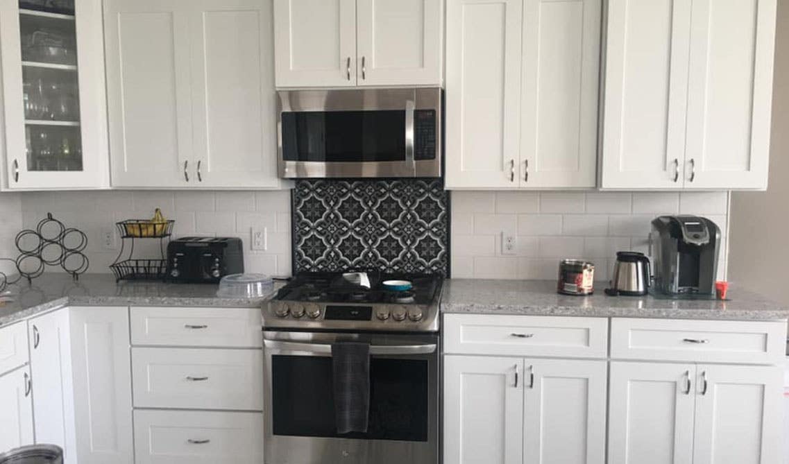 All white kitchen with shaker cabinets and crown molding