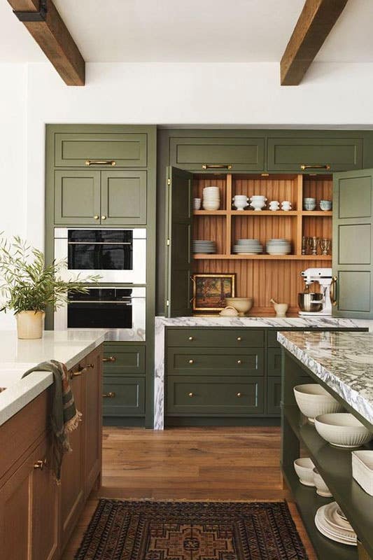 Army Green Kitchen Cabinets paired with wooden elements like exposed beams and flooring