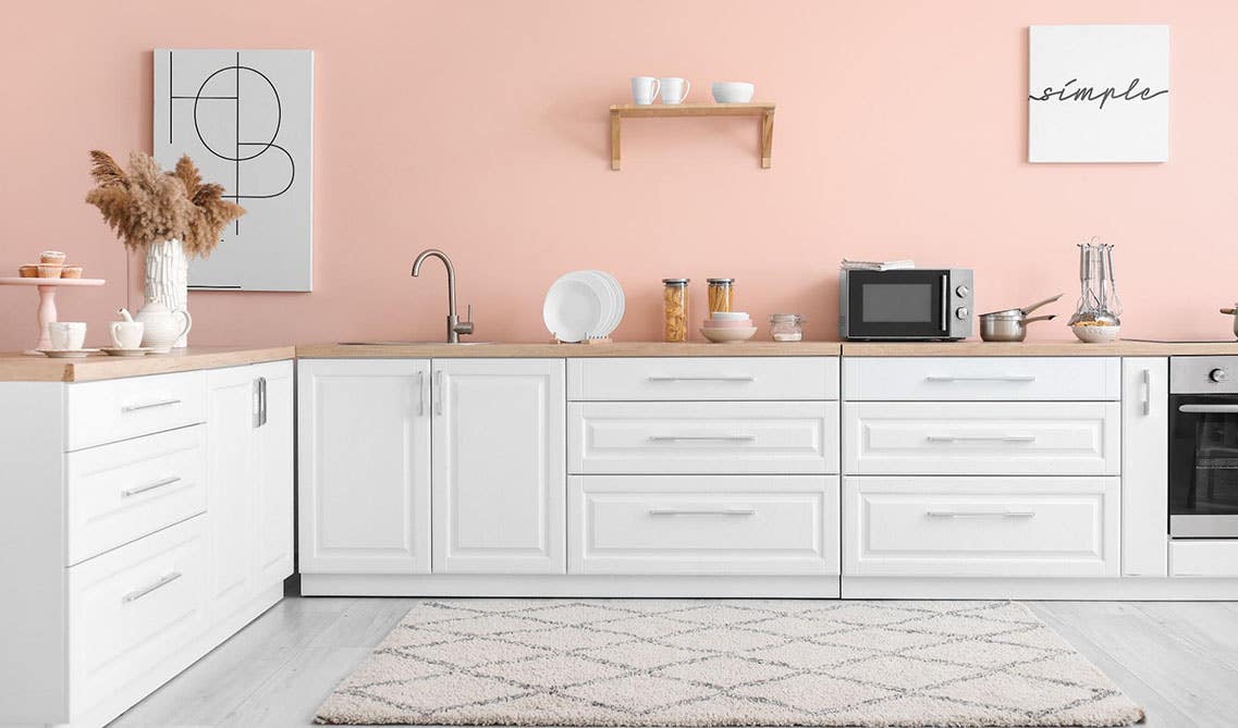 Pink wall and white cabinet kitchen