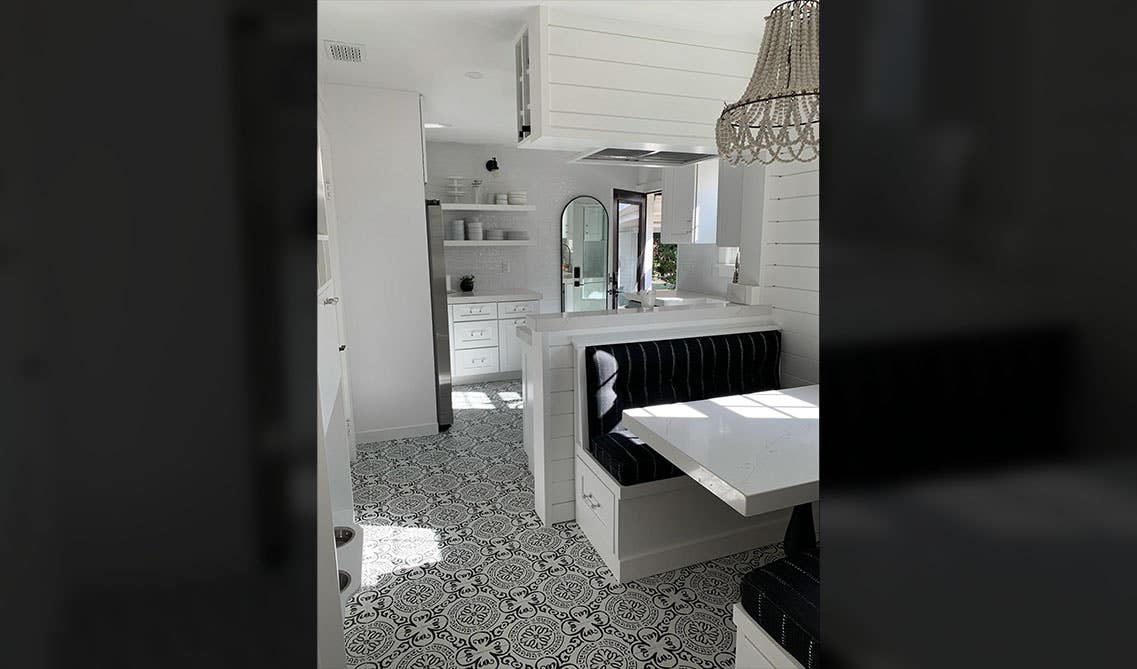 banquette white kitchen layout with a built-in bench seating area and open shelving storage 