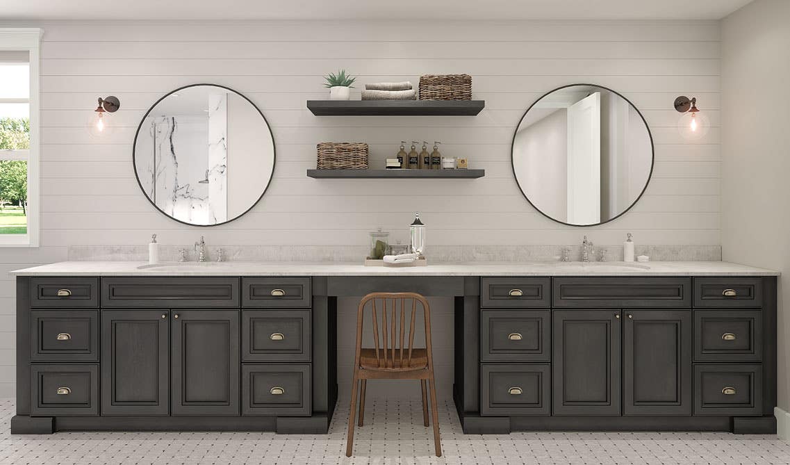 Modern bathroom with floating shelves, cabinets and round mirrors