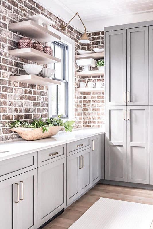 Modern rustic kitchen with brick style backsplash and gray cabinets