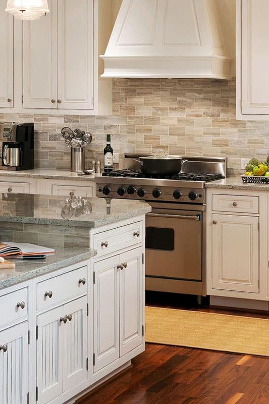 Beige Brick Backsplash with Grey Countertop and bright white cabinets