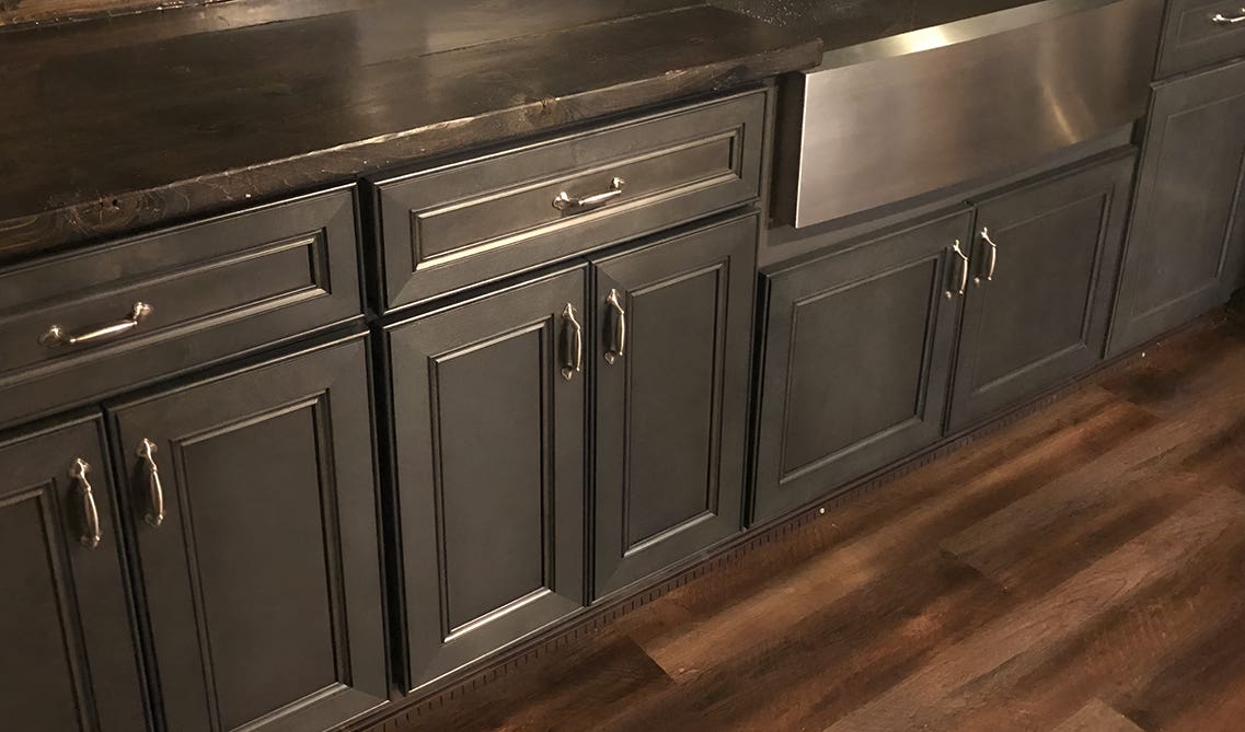 Black base cabinets paired with silver hardware