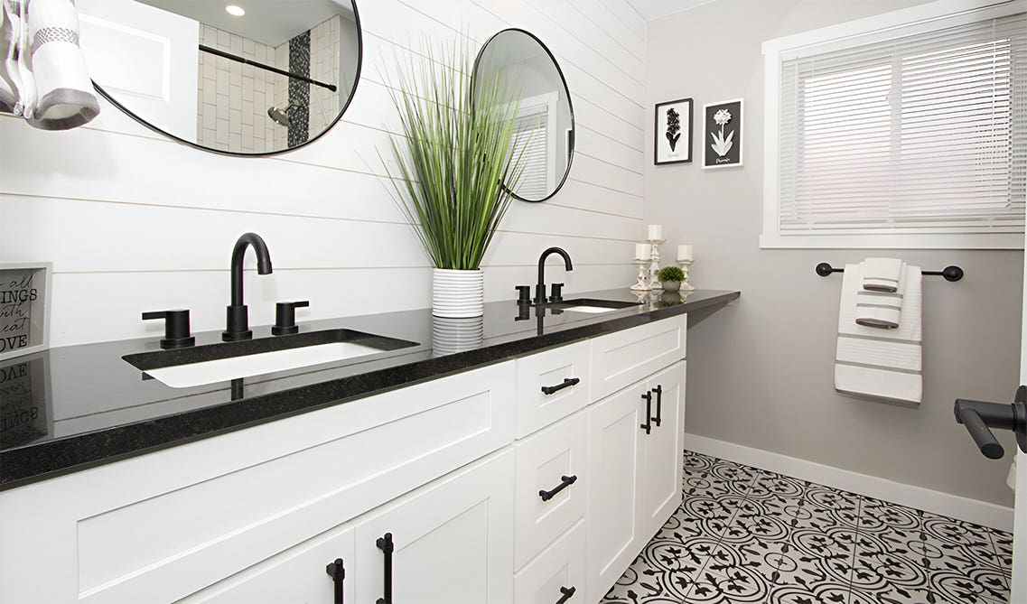 Black and white bathroom with black countertop 
