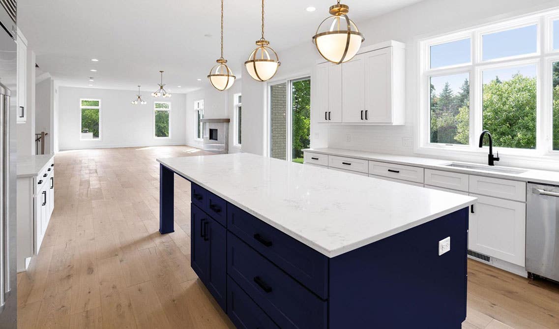 Blue and white Kitchen island with pendent lights