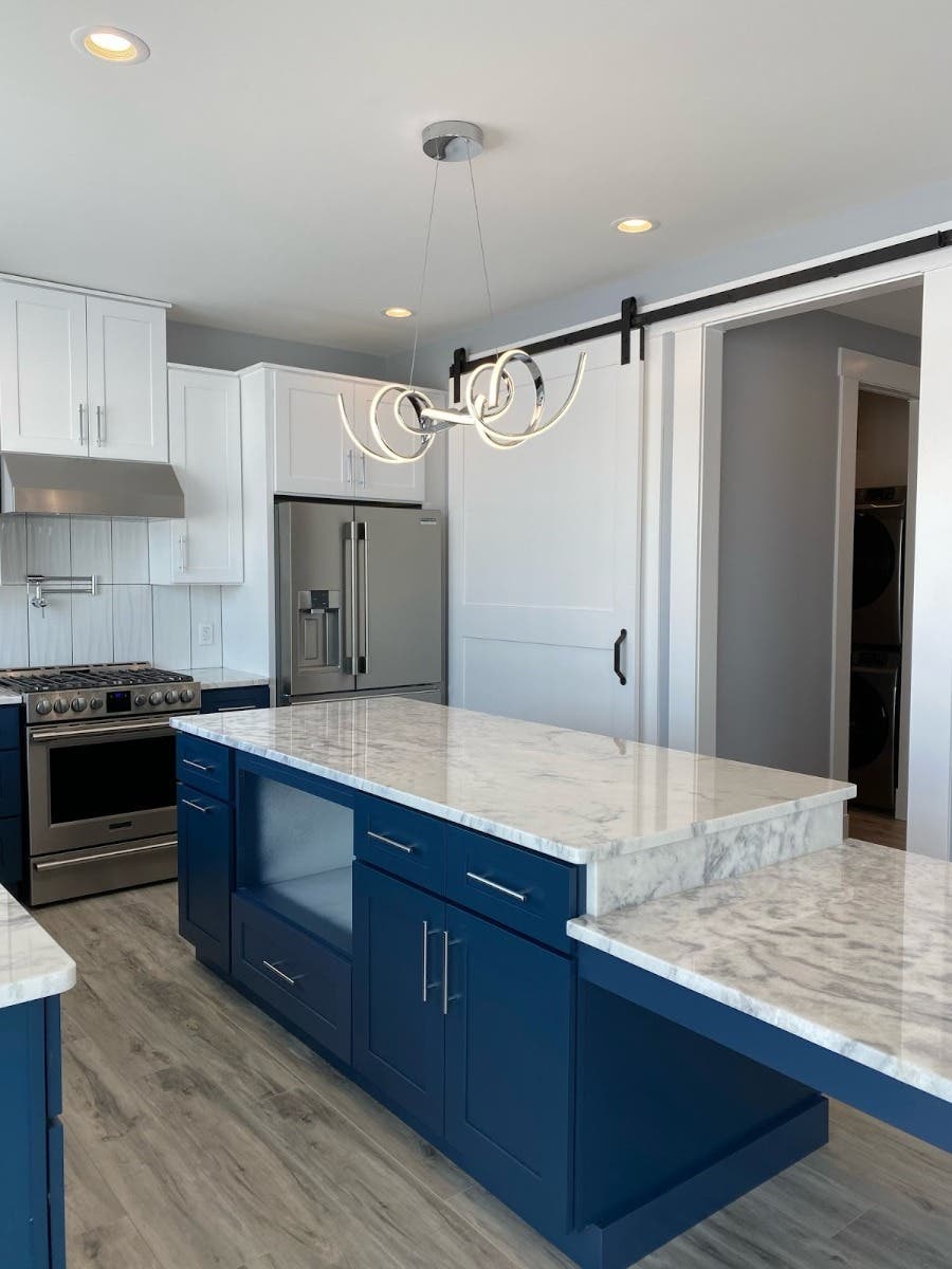 Blue Cabinets kitchen with statement light