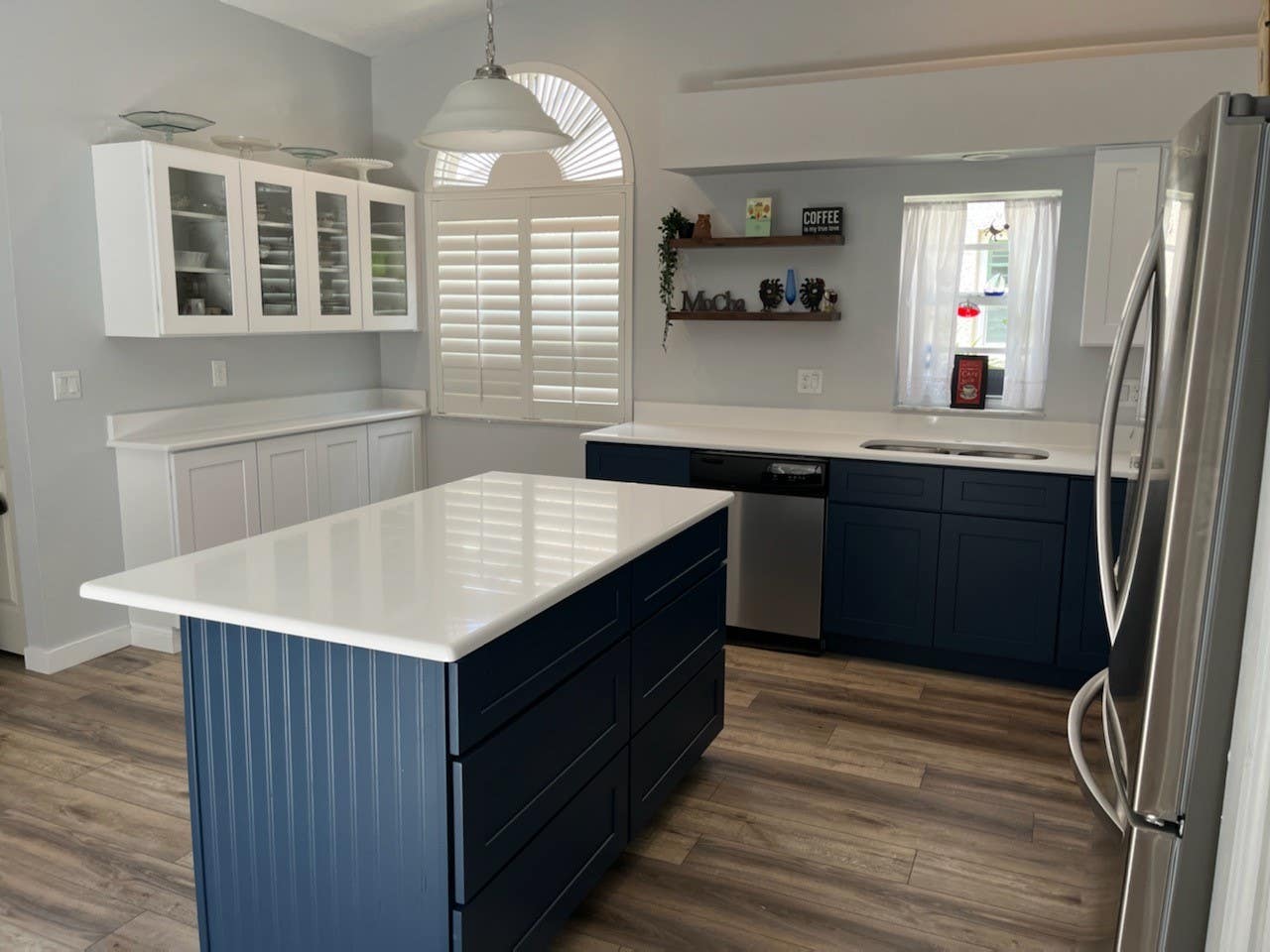 Blue lower cabinets with white countertops