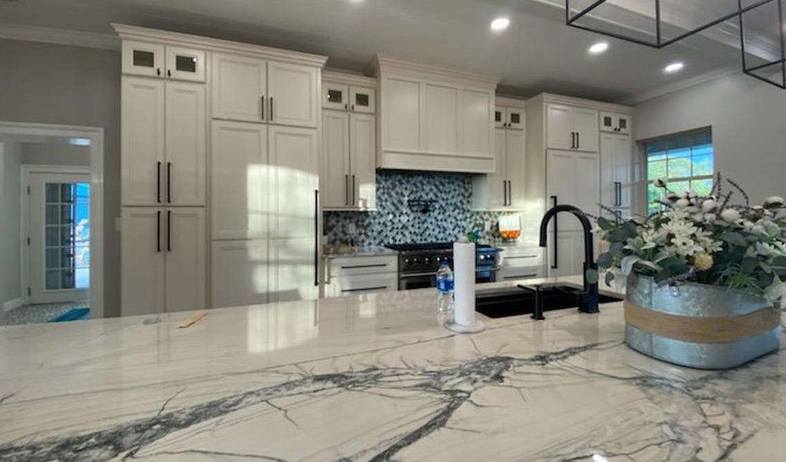 Blue marble countertops with blue and white subway tiles