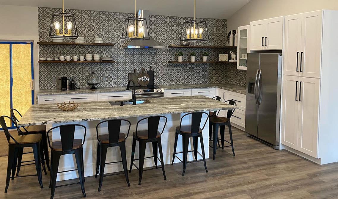 Bold Pattern tile paired with floating shelves and white cabinets