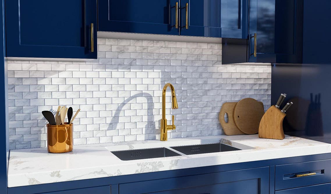 Bold Kitchen Design features navy blue cabinets, bright white countertops and a white subway tile backsplash