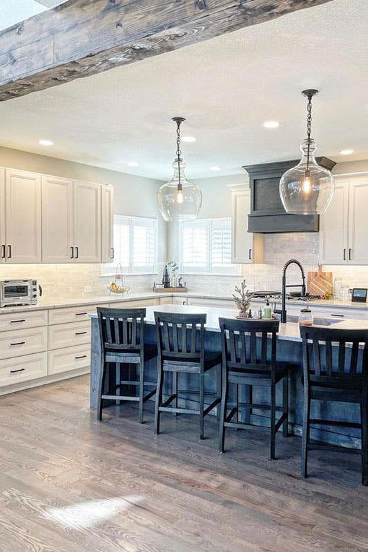 A kitchen island with counter-height chairs