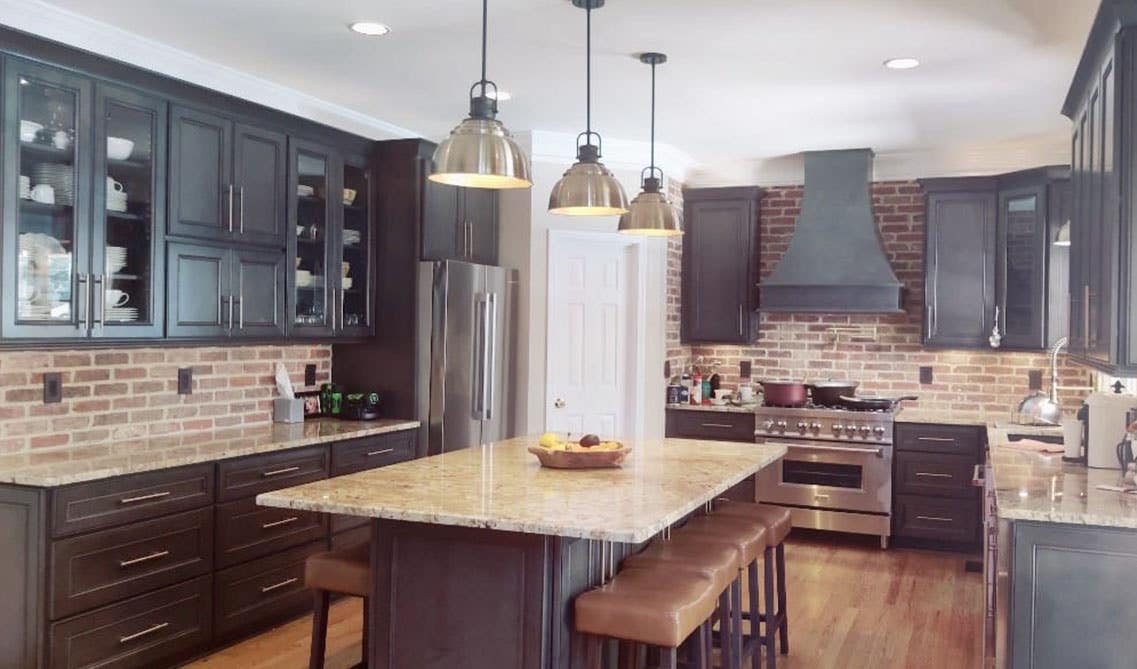 Brick style backsplash with black cabinets