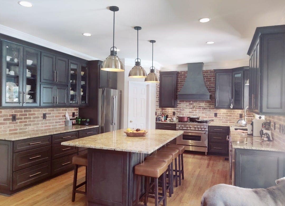 Brick backsplashes paired with driftwood gray kitchen cabinets