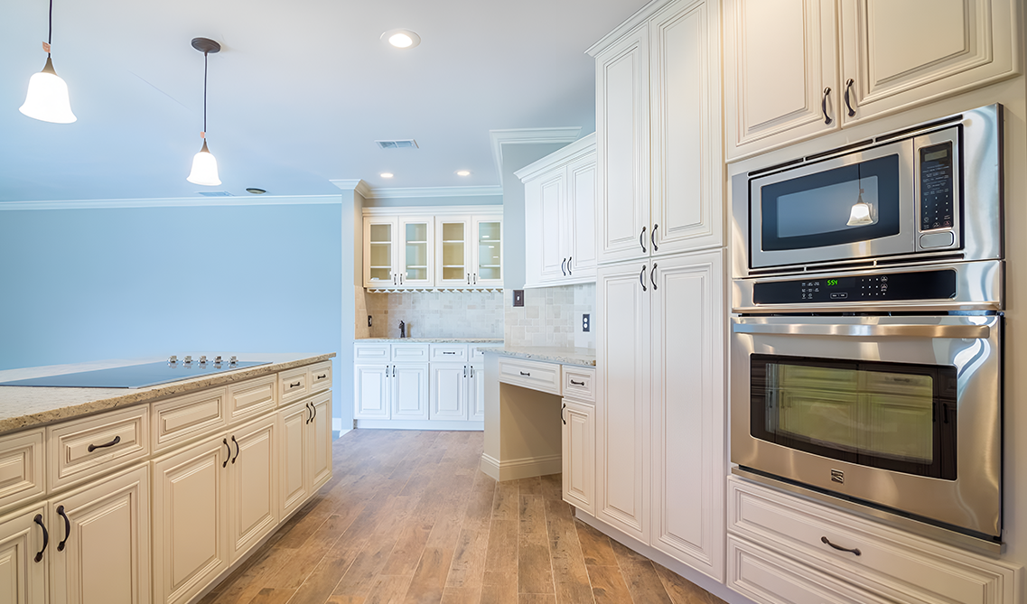 Bristol linen kitchen cabinets paired with stainless steel appliances and smart storage solution