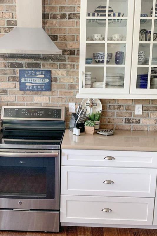 Brown Brick Backsplash with Brown Countertops and white shaker cabinets