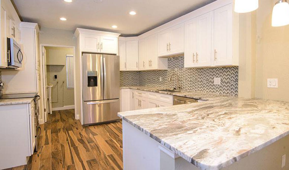 white cabinets with silver hardware paired with stainless steel appliances 