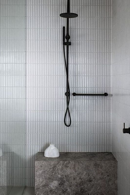 Add Built-In Shower Seating with matt black shower fixture