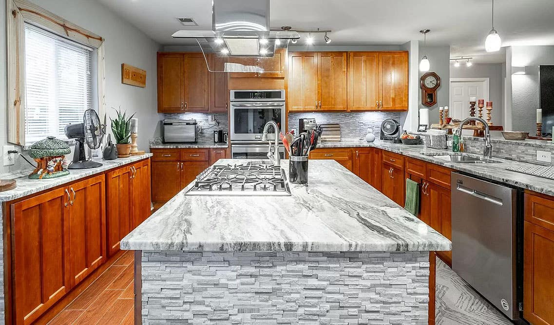 Kitchen design with brown cabinets and gray wall combination