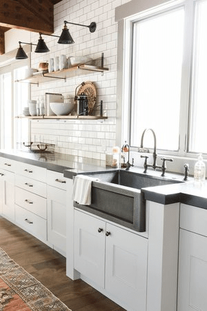 glossy white subway tile blends flawlessly with the white shaker cabinets