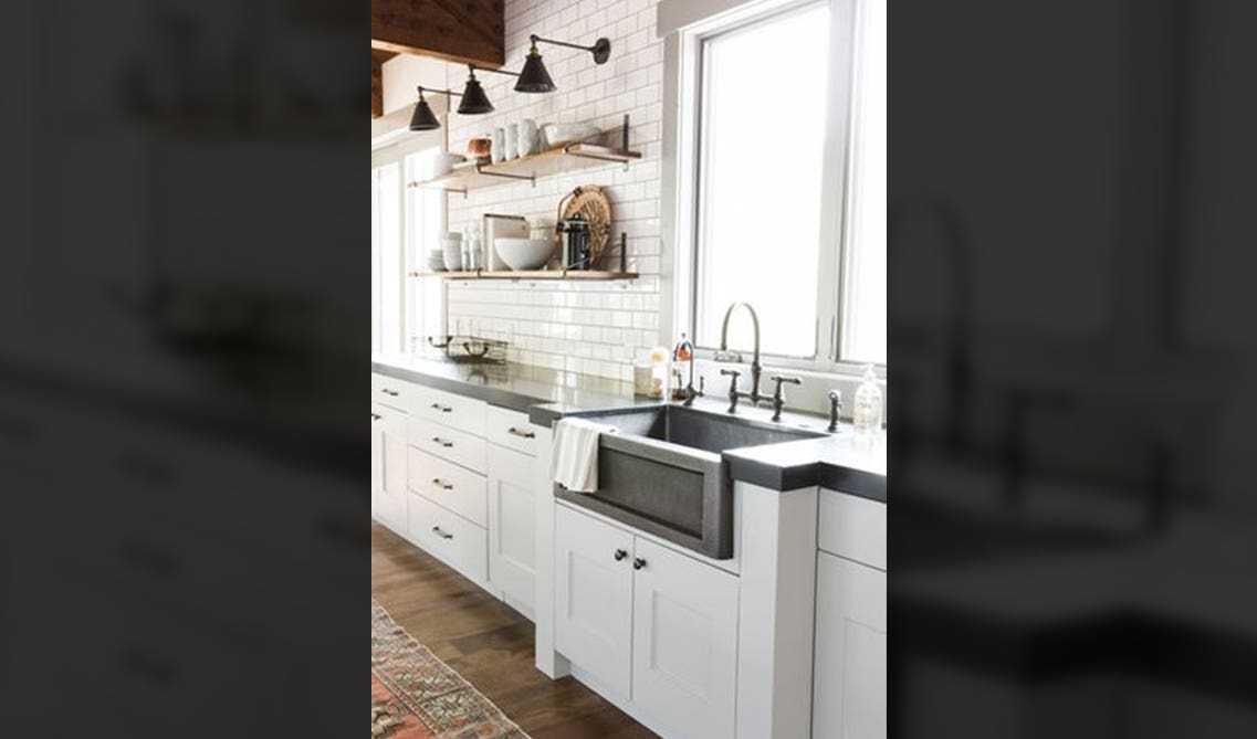 glossy white subway tile blends flawlessly with the white shaker cabinets