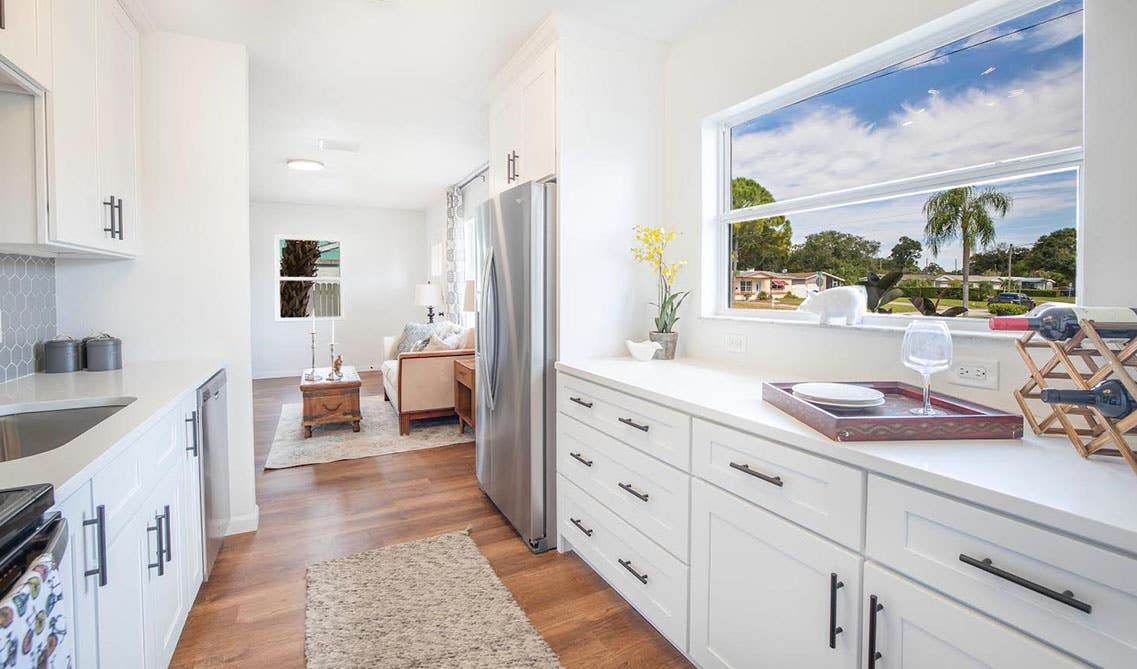 White kitchen design with shaker cabinets and stainless steel appliances 