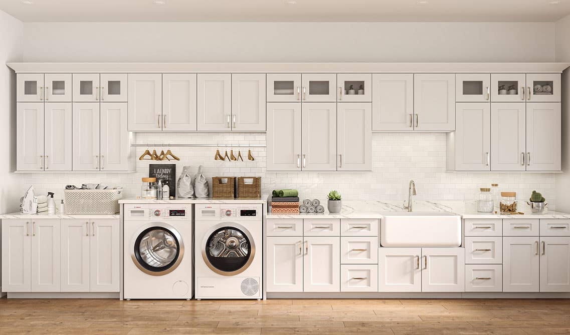 Laundry Room with white shaker cabinets, washer and dryer, built-in sink, marble countertop and spc flooring